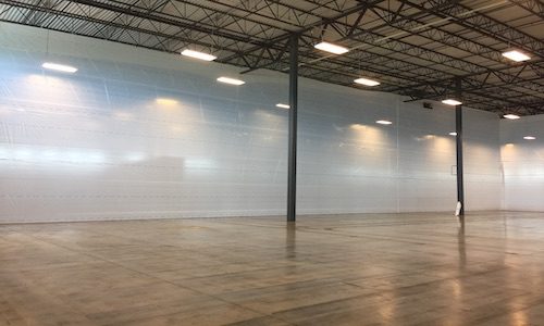 empty warehouse with dust containment wall