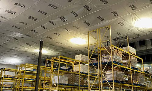 temporary suspended ceiling above warehouse shelves